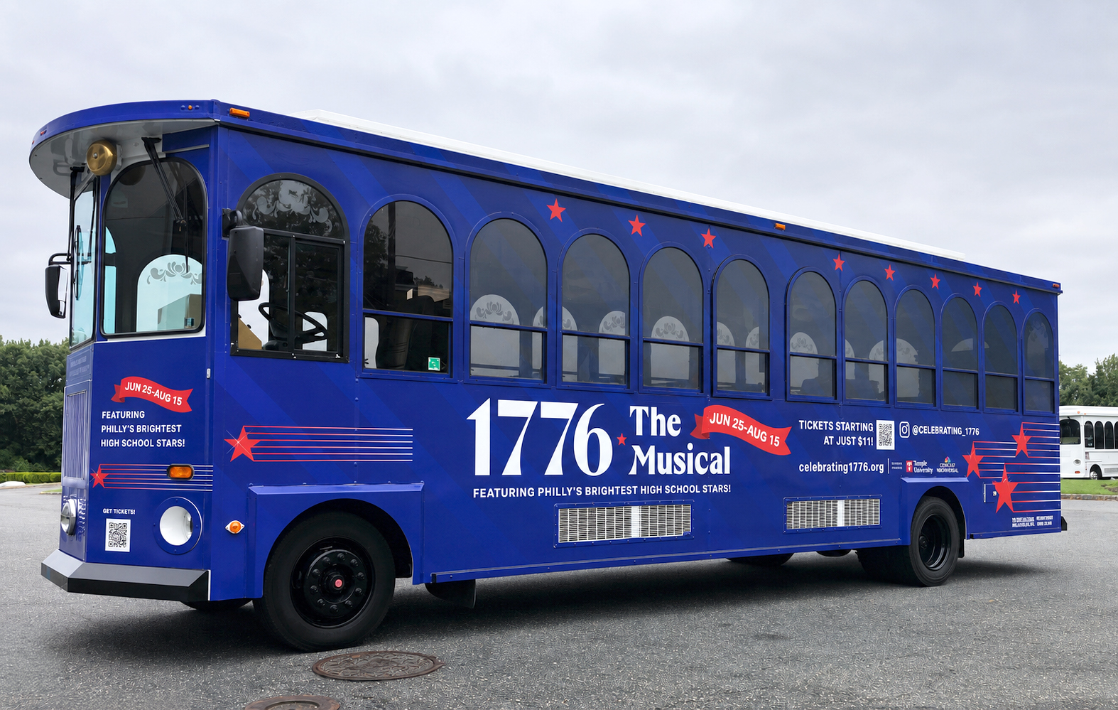 Blue trolley wrapped with promotional graphics for 1776: The Musical.